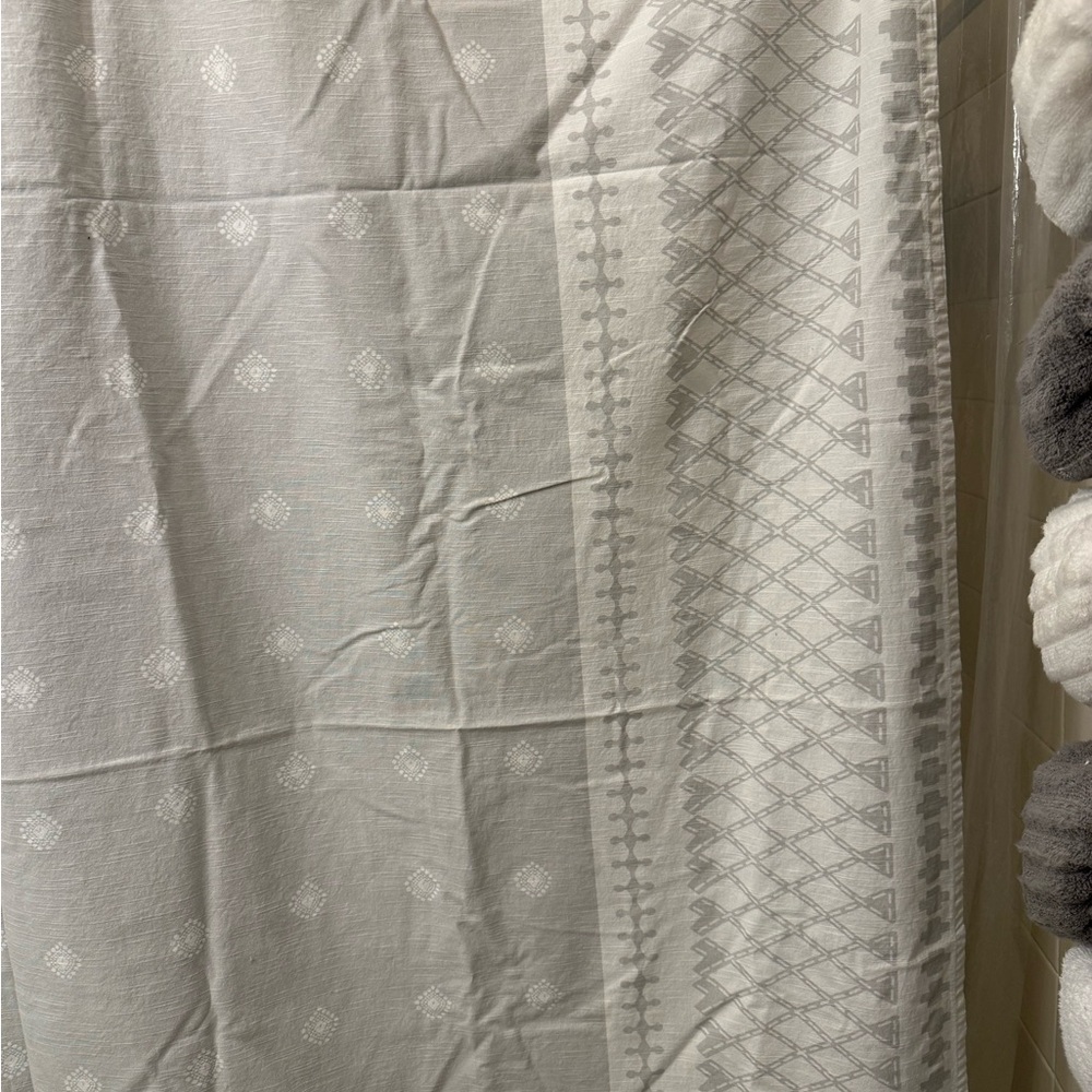 Gray and white shower curtain with tassels